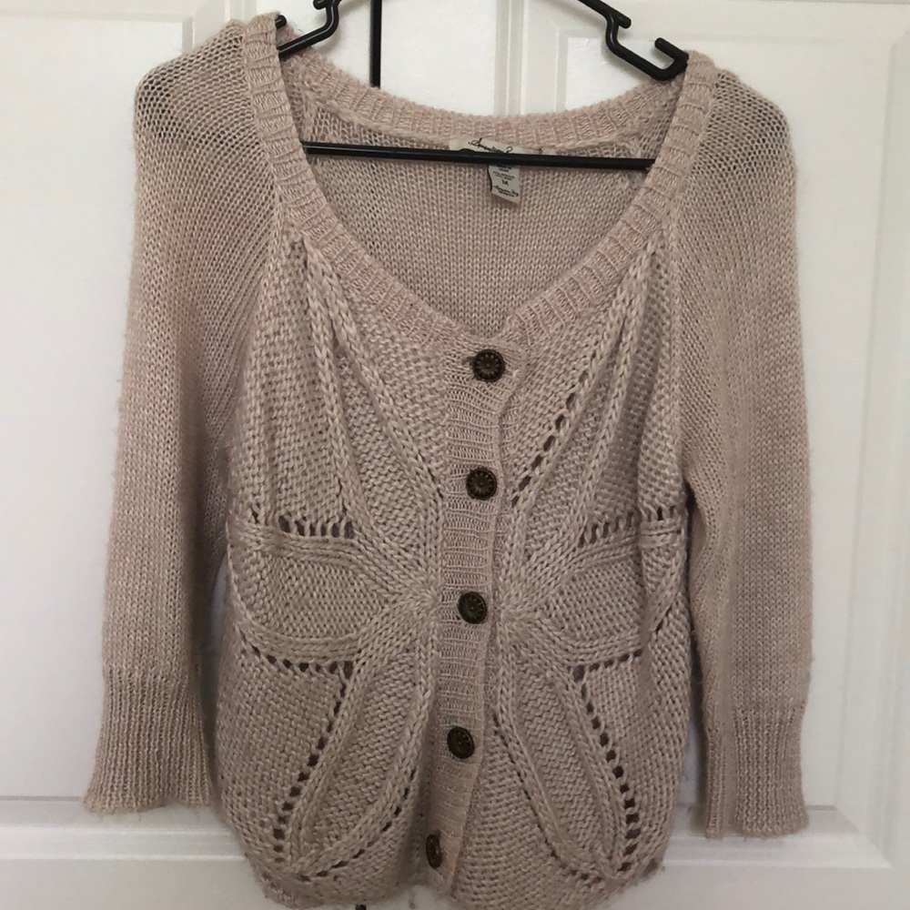 Knit sweater with flower detail.